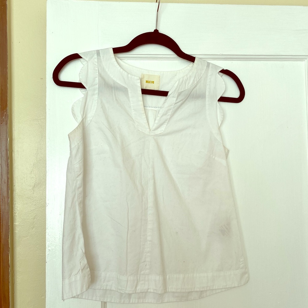 Anthropologie white tank with scalloped sleeves.